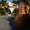 Grande giara, sdraio e palme su una terrazza.